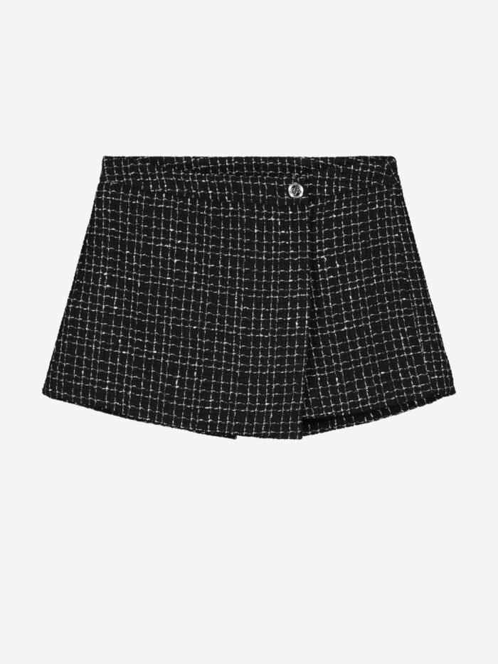 Nik&Nik Meisjes skort - Tasmin - Zwart Deze Nik&Nik skort in zwart is perfect voor meisjes die stijlvol en comfortabel willen zijn. Het tweed patroon maakt hem extra bijzonder. Combineer met een blazer of een leuke top.Materiaal